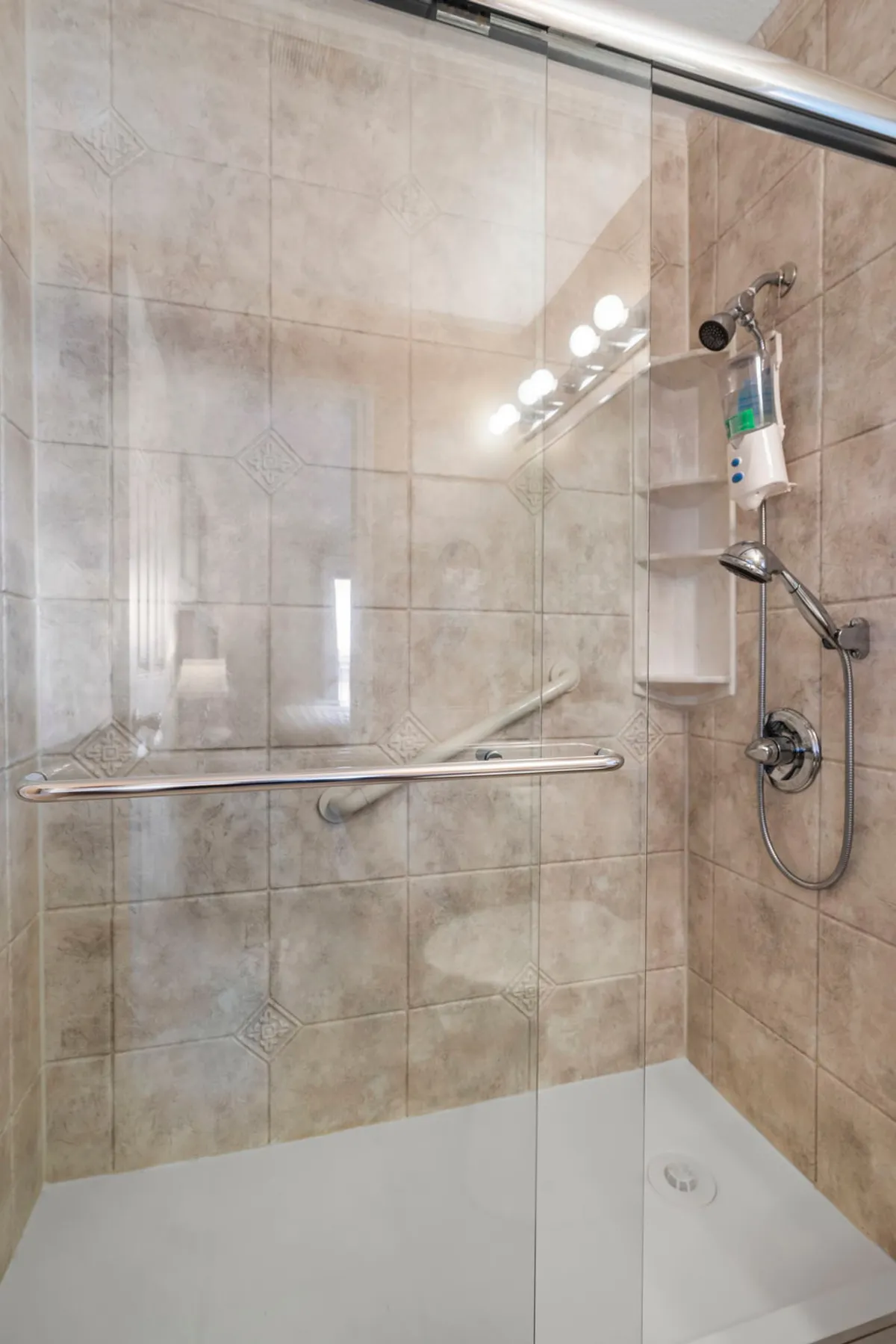 A modern en suite bathroom with a glass shower enclosure, stylish fixtures, and elegant tiled walls. The space exudes a spa-like feel, inviting relaxation and rejuvenation after a long day.