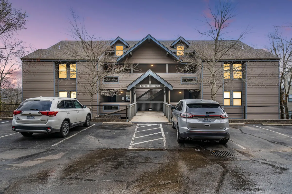 A welcoming exterior shot of the building’s main entrance and parking area, set against an open sky. The inviting facade suggests comfort and accessibility while highlighting the ease of coming and going for various outdoor excursions.